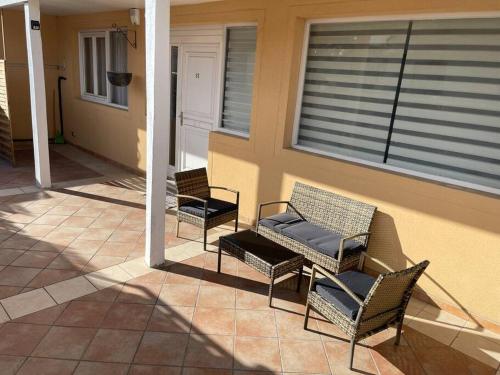 three chairs and a table on a patio at Appartement cosy terrasse parking 20 mn Paris in Savigny-sur-Orge