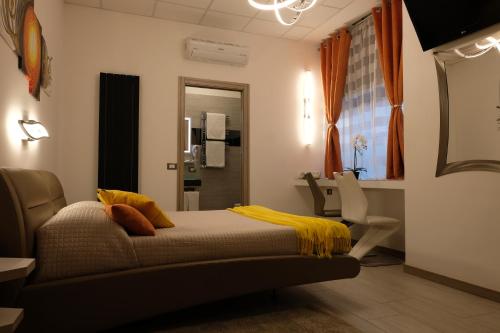 a bedroom with a bed with a yellow blanket at LeNotti Verona in Verona