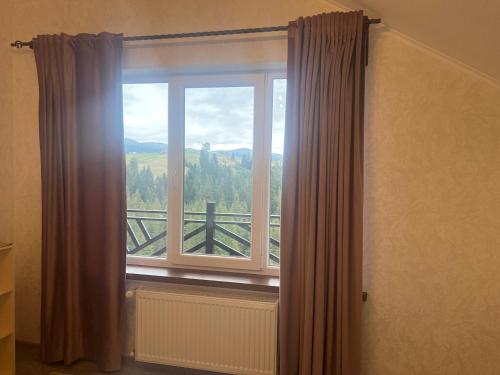 a window with a view of a mountain at Мелодія Гір .Апартаменти з видом на гори . in Vorokhta
