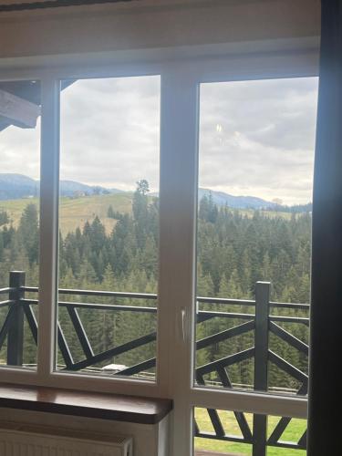 a window with a view of the mountains at Мелодія Гір .Апартаменти з видом на гори . in Vorokhta