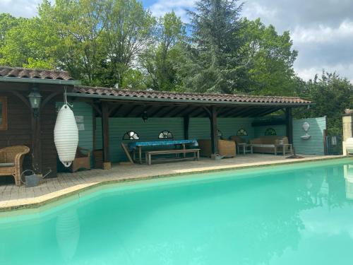 a pool house with a pool table and a gazebo at Le bon chemin Studio Stockholm in Sainte-Nathalène