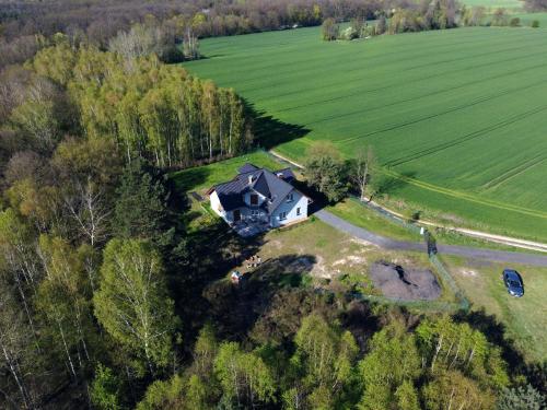 an aerial view of a house in a field at Kraniec Świata Unique Location Stylish Secured Parking Peace and Quiet Self Check-In in Bolesławiec