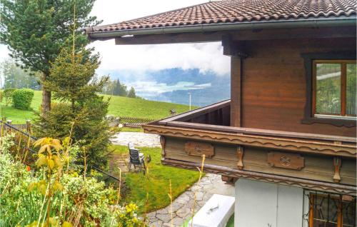 a house with a view of a garden next to a building at Gemuetliches Ferienhaus - Pill in Pill