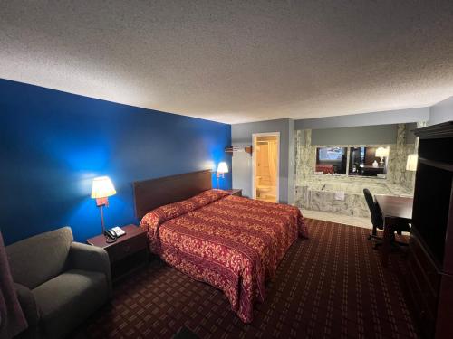 a hotel room with a bed and a couch at Executive Inn and Suites - Jackson in Jackson
