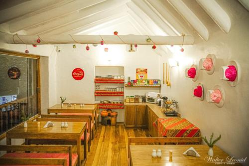 a restaurant with wooden tables and chairs in a room at Kutty Wasi in Cusco