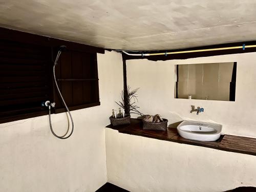 a bathroom with a sink and a mirror at The Hidden Gem in Ban Nok