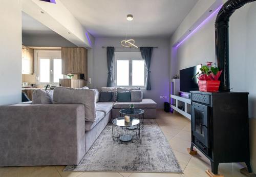 a living room with a couch and a fireplace at MegaLuxe Apartment in Heraklio Town