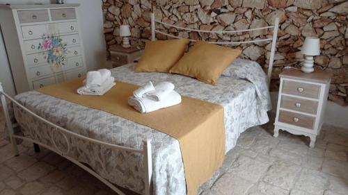 a bedroom with a bed with towels on it at Le Pajare B&b in Sava
