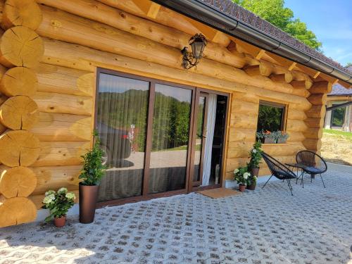 a log cabin with a large sliding glass door at Chalet -VV in Podčetrtek