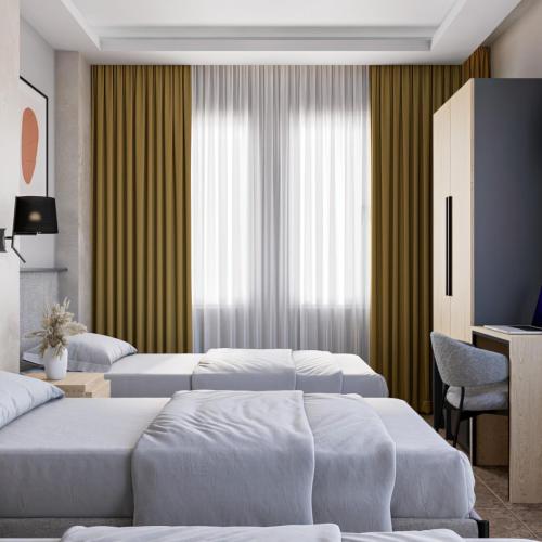 a hotel room with three beds and a television at Medi Otel in Samsun