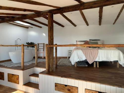 a room with a bath tub and a bed in a room at Romantic eco retreat in Adeje