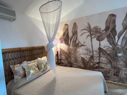 a bedroom with a bed with a mosquito net on it at Villa Giglio in Torre delle Stelle