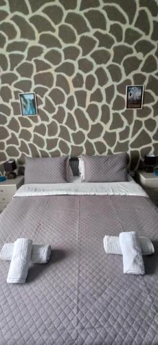 a bedroom with a bed with two white socks on it at Windy Place in Fourfourás