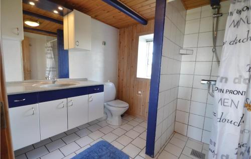 a bathroom with a toilet and a sink at 5 Bedroom Stunning Home In ster Assels in Ljørslev