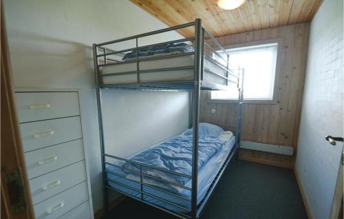 a bunk bed room with two bunk beds and a window at 5 Bedroom Stunning Home In Øster Assels in Øster Assels