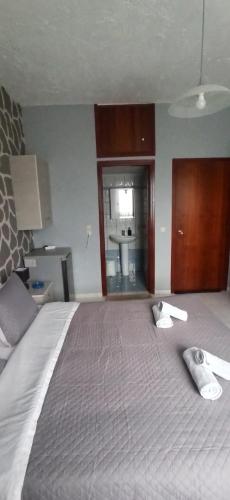 a bedroom with a bed with two towels on it at Windy Place in Fourfourás