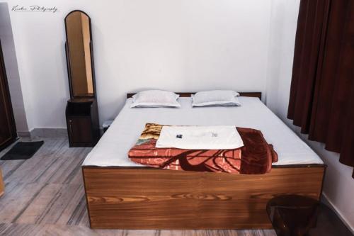 a bedroom with a bed with a wooden frame at Kopai View in Bolpur