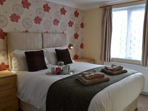 a bedroom with a large bed with towels on it at Shepherds Retreat in Saint Ervan