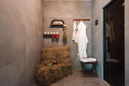 a bathroom with a stack of hay and a shelf with a toaster at La Mesteceni & Loc cu Stări de Bine, SPA adult only in Sălicea