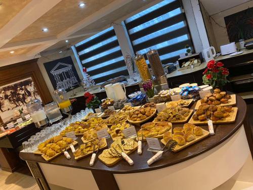 a table filled with lots of different types of food at Theranda Hotel in Prizren