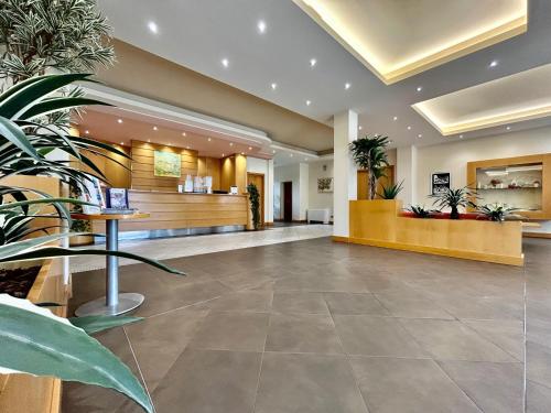 a lobby of a hospital with potted plants at Hotel Ristorante Trendy in Prato