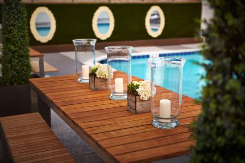 a table with candles and vases and a pool at The Ven at Embassy Row, Washington, D.C., a Tribute Portfolio Hotel in Washington