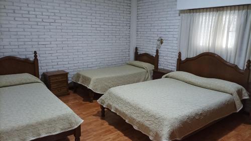 En eller flere senge i et værelse på Hotel Americano
