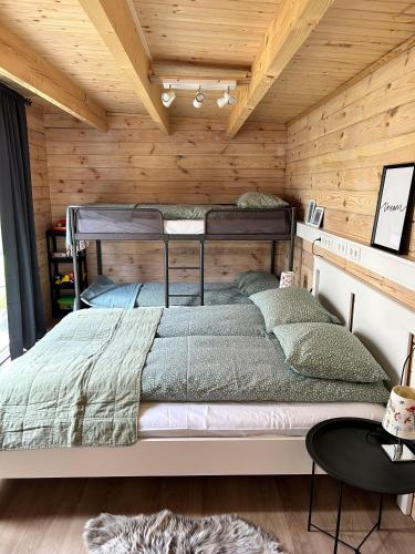 a bedroom with a bed in a wooden wall at The Little Guesthouse Downtown - Keflavik Airport in Keflavík