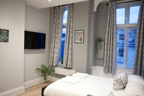 a bedroom with a large bed and a window at Studio On The Rows - Central City Centre in Chester