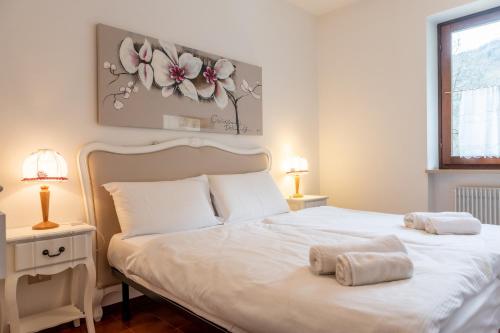 Postel nebo postele na pokoji v ubytování Residence Ledro