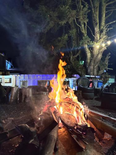 a fire pit with flames and smoke at night at Eco Hotel Terrabella in Santa Elena