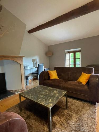 a living room with a couch and a coffee table at Logis Hôtel Château De Palaja in Carcassonne