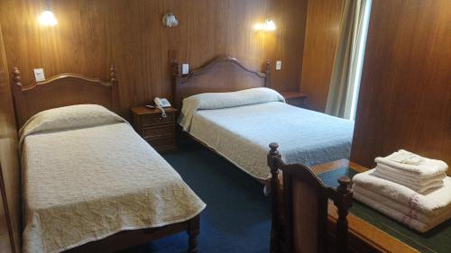 En eller flere senge i et værelse på Hotel Americano