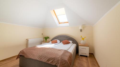 a small bedroom with a bed and a window at Ledan in Chłopy