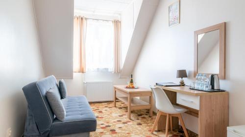 a room with a desk and a chair and a mirror at Ledan in Chłopy