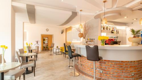 a restaurant with tables and chairs and a bar at Ledan in Chłopy