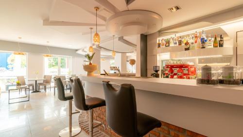 a bar in a restaurant with black chairs at Ledan in Chłopy