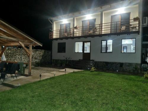 a large house with a yard at night at Escape in Dubova