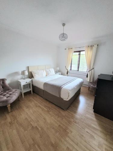 a bedroom with a large bed and a window at Grange House B&B in Galway