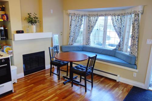 ein Wohnzimmer mit einem Tisch, Stühlen und einem Sofa in der Unterkunft Bright Garden Suite by the Beach and UBC in Vancouver