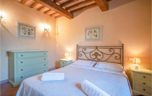 a bedroom with a white bed and two dressers at Antonio in Izzalini