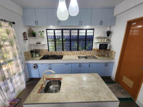 a kitchen with a sink in the middle of it at Viner's Inn in Tacloban