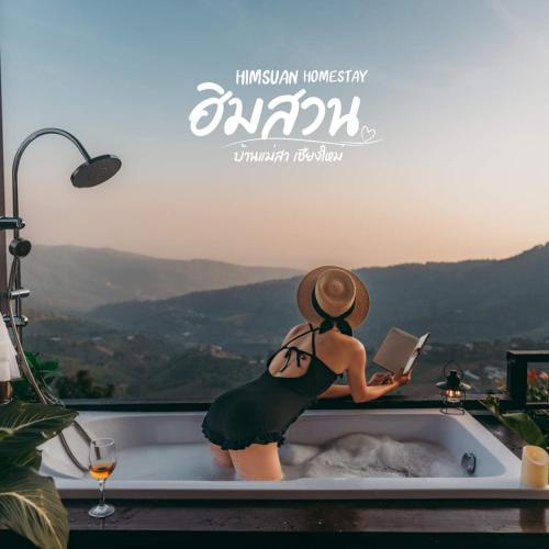 a woman sitting in a bath tub reading a book at ฮิมสวน โฮมสเตย์ Him suan homestey in Ban Thung Phan Ha