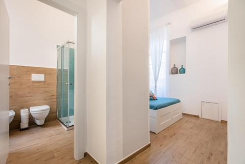 a bathroom with a shower and a toilet and a mirror at Mariviva Guest House in Terracina