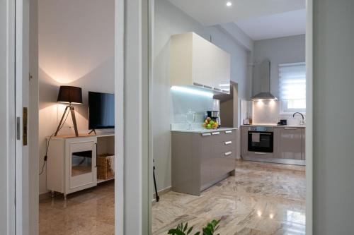 a kitchen with white cabinets and a counter top at Anesis with a Yard in Kalamata