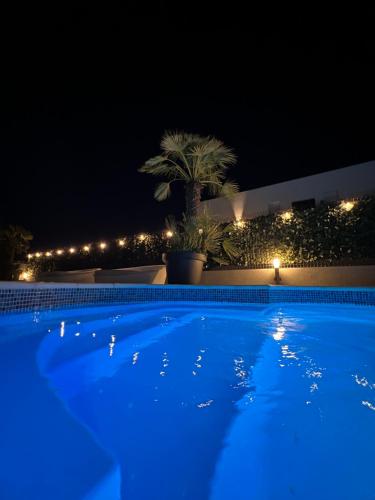 una grande piscina notturna con luci blu di Sunluxvilla ,Heated Pool, IR Sauna a Kaštela (Castelli)