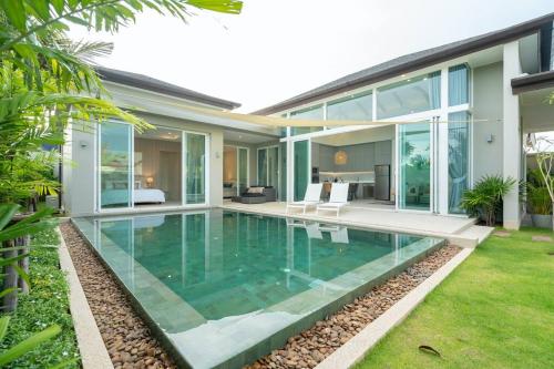 a swimming pool in the backyard of a house at Peykaa Estate Pool Villa by HCR in Phuket Town