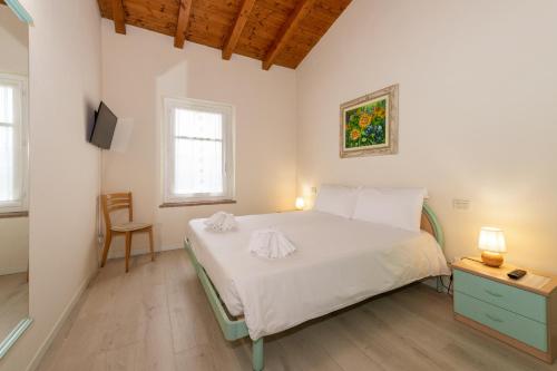Ένα ή περισσότερα κρεβάτια σε δωμάτιο στο Bertoletta Village Apartments