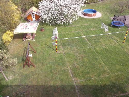 an aerial view of a backyard with a tennis court at Chalupa Erika in Dobšín