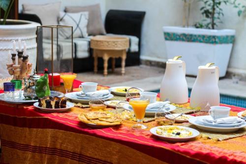 a table with plates of food and drinks on it at RIAD KECHMARA in Marrakesh
